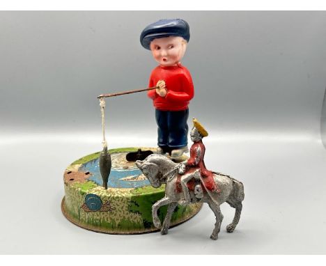 Mettoy tin plate Billy the fisherman, incomplete but clockwork working, with a small lead military horseman figurine  / All l