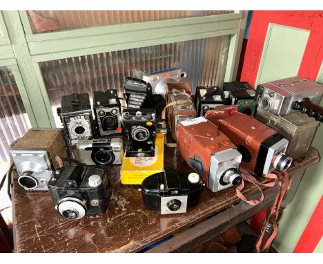 A quantity of photo and video cameras including Kodak, Super 8, Fujifilm and Conway, with associated cases  / All lots are lo