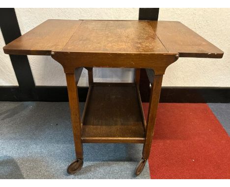 A mid-century oak two-leaf folding tea caddy with platform underneath, on original casters, 70cm (h) x 87cm (w) x 62cm (d)  /