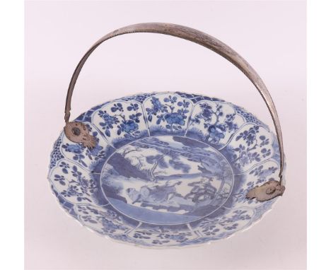 A blue/white porcelain plate with second grade 835/1000 silver handle of a later date, China, Kangxi, around 1700. Blue under