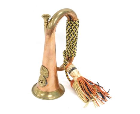 A 20thC copper and brass bugle, with Royal Welsh Fusilier's emblem, 27cm high. 