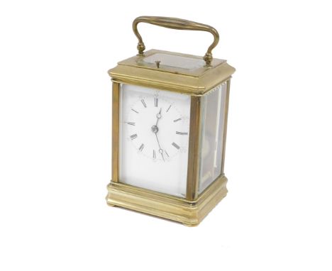 A late 19thC brass repeating carriage clock, with 7cm wide Roman numeric and Arabic dial, on compressed feet, with barrel mov