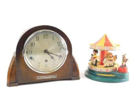 A Corgi Toys Magic Roundabout musical automaton, and an oak cased chiming eight day mantel clock, with 14cm diameter Arabic d