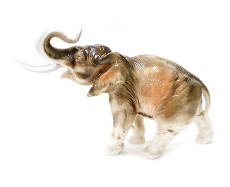 A 20thC Royal Dux pottery figure of an elephant, trunk raised, marked beneath, 40cm high. 