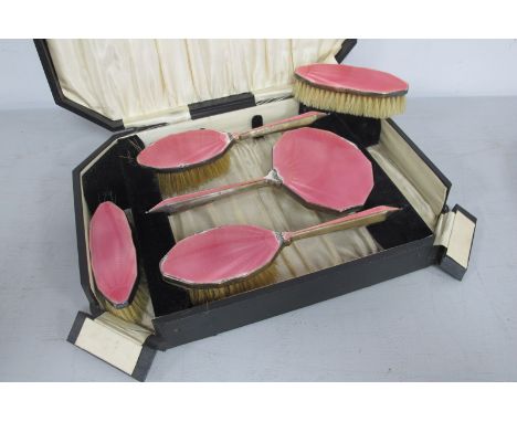 A Hallmarked Silver and Pink Enamel Five Piece Dressing Table Set, DM Co, Birmingham 1931, (damages / enamel loss), in origin