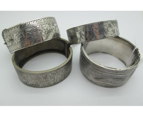 Two Wide Hallmarked Silver Hinged Bangles, with engine turned and engraved decoration (dents / damage); together with another
