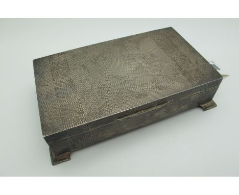 A Hallmarked Silver Cigarette Box, Walker &amp; Hall, Birmingham 1957, of shallow rectangular form, allover engine turned, on