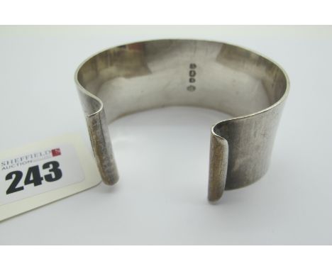 A Modernist Wide Hallmarked Silver Bangle, DRM, Sheffield 1957, of plain design. 