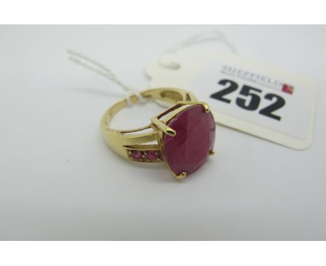 A Large 18ct Gold Single Stone Ruby Dress Ring, oval four claw set, between tapering pierced and inset shoulders (finger size