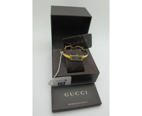 Gucci; A Modern Gold Plated Ladies Wristwatch, 1500L with elongated rectangular black dial, in original box with booklet and 