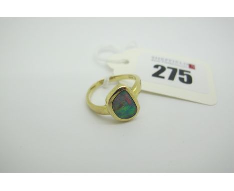 A Modern 14ct Gold Black Opal (Doublet?) Single Stone Dress Ring, of abstract shape rub over set (closed back setting) (finge