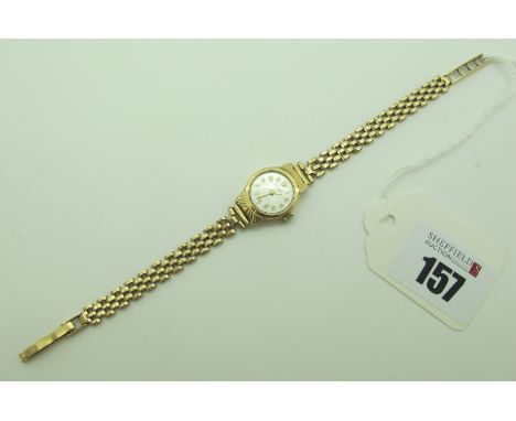 A 9ct Gold Ladies wristwatch, the circular signed dial wit Arabic numerals, within plain case, with textured detail, to 9ct g