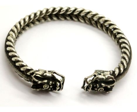 White metal Tibetan silver bangle with dragon head terminals, D: 8 cm. P&amp;P Group 1 (£14+VAT for the first lot and £1+VAT 