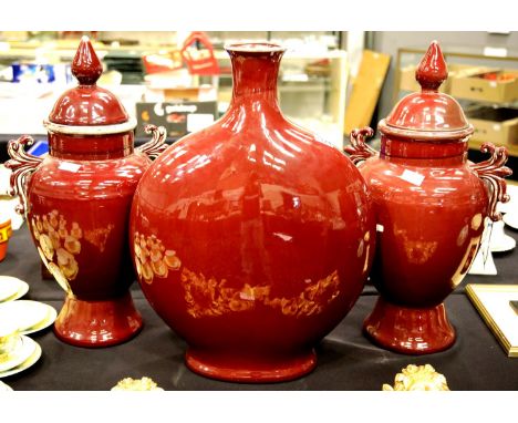 Large Sang De Boeuf ceramic moon flask in red glaze, H: 61 cm, with a pair of large temple urns, H: 60 cm. (one cover damaged