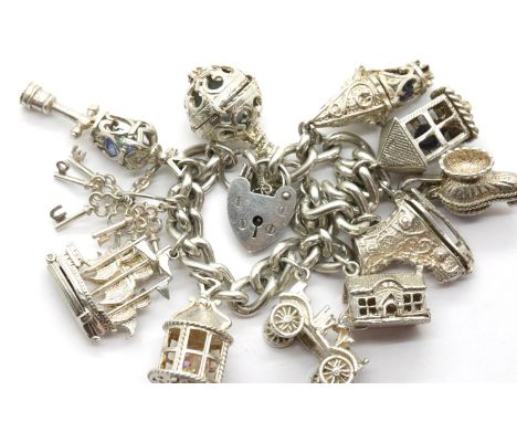 Silver charm bracelet with eleven charms, 92g. P&P Group 1 (£14+VAT for the first lot and £1+VAT for subsequent lots)Conditio