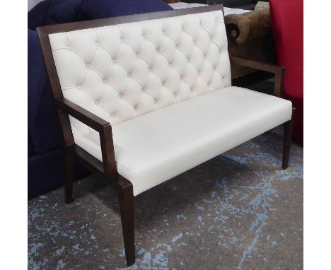 BENCH, of small proportion open arms in buttoned leather on square supports.