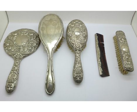 A four piece silver brush, comb and mirror set and a silver backed brush 