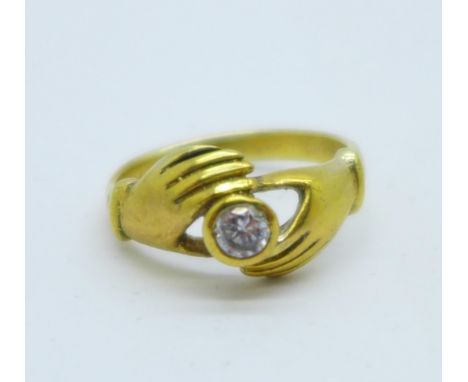 A silver gilt ring set with a white stone, M 