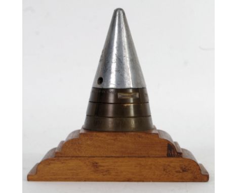 An interesting Second World War WWII Artillery Shell Fuse Head Timer (inert) converted to a table lighter on a wooden base, t