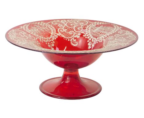 A Venetian ruby glass footed bowl, with white painted lattice and scroll work decoration, with four reserves depicting Veneti