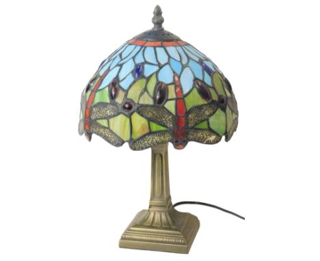 A Tiffany style table lamp, with a dragonfly leaded glass shade, in red, blue and green, on a cast metal base, 36cm high.