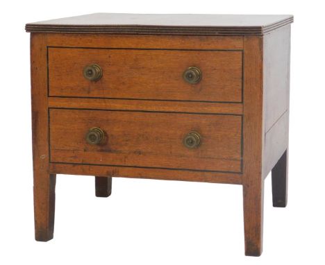A Georgian oak commode, the hinged top with a reeded edge above a two drawer false front, raised on square legs, 48cm high, 5