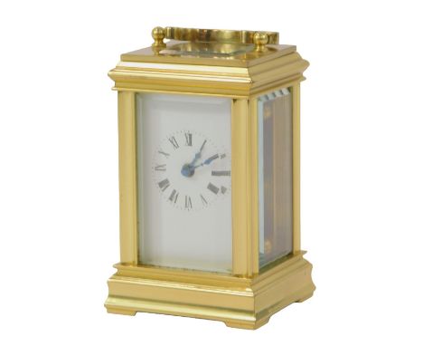 A 20thC brass cased miniature carriage clock, the rectangular white enamel dial bearing Roman numerals, drum barrel movement,