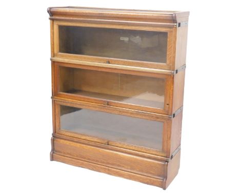 A 20thC oak three sectional Globe Wernicke bookcase, with glass doors, bearing label, 105cm high, 85cm wide, 27cm deep. 