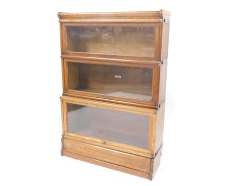 A 20thC oak three sectional Globe Wernicke bookcase, with glass doors, bearing label, 128cm high, 85cm wide, 27cm deep. 