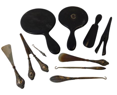 Various silver handled and stainless steel bladed button hooks and glove stretchers, and an ebonised back and silver initiall