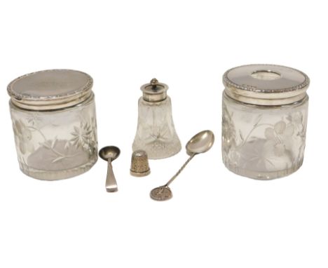 A small group of cut glass and silver wares, comprising two silver topped dressing table jars, a silver plated salt spoon, si
