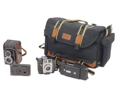 A Minolta Autochord twin lens reflex camera, in a partial leather case, together with a Brownie Twin 20 camera, an Eastman Ko