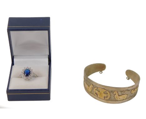 Two items of jewellery, comprising a Middle Eastern style bangle, decorated with camels and Egyptian hieroglyphs, stamped 925