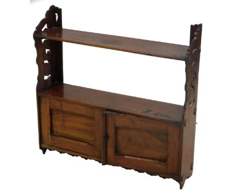A Victorian mahogany hanging display shelf, two shelves above two panelled cupboards with pierced and scrolling sides, 52cm h