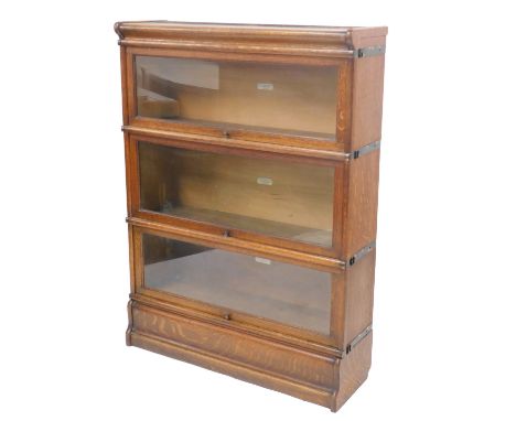A 20thC oak three sectional Globe Wernicke bookcase, with glass doors, bearing label, 117cm high, 86cm wide, 26.5cm deep. 