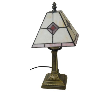 A Tiffany style table lamp, the square tapering shade with purple and red diamond decoration against an off white ground, on 