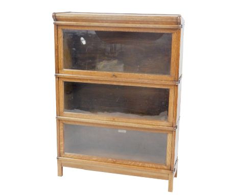 A 20thC oak three sectional Globe Wernicke bookcase, with glass doors, bearing label, 120cm high, 86cm wide, 31cm deep. (AF)