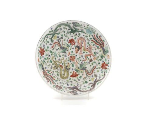 A Chinese wucai charger,  20th century, of circular form, the centre painted with two dragons and two phoenixes among peony, 
