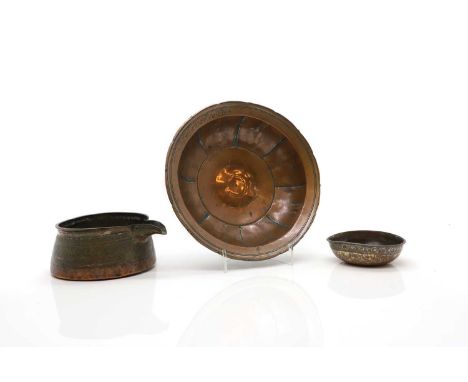 A collection of Eastern copper items comprising a Syrian lipped bowl, possibly 16th/17th century, of tinned copper with kufic