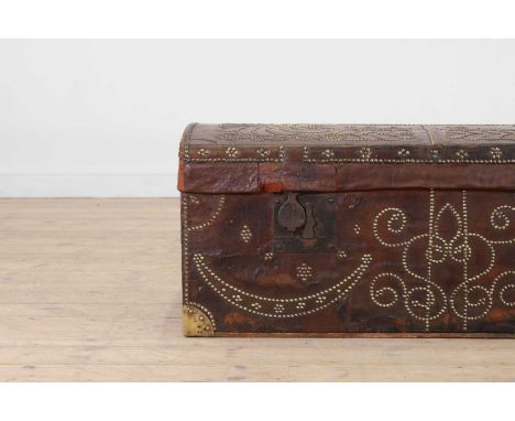 A studded leather trunk, 19th century and later, the domed top initialled 'M.A.P.', with all-over foliate detail and brass an