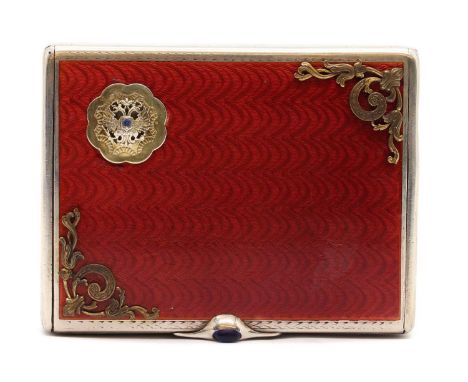 A Russian enamelled silver cigarette case, the red guilloche enamel lid with applied scrolled gilt corners and double-headed 