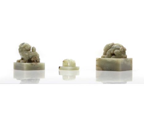 Three Chinese jade seals,  20th century, of square form, each finial carved with a mythical beast,  3.6 to 6cm long (3)  Cond