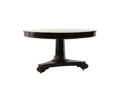 A William IV rosewood centre table c.1830, the circular top with a crossbanded edge, above a spreading octagonal column and a