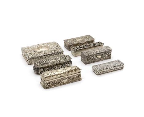 A group of seven silver boxes all with floral and foliate decoration, comprising a large rectangular example, Birmingham 1902