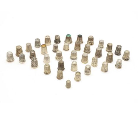 A large collection of silver thimbles comprising 80 examples, with various engine turned, engraved, and hardstone inset decor