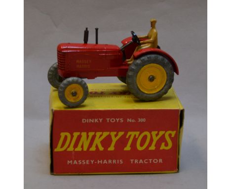 Dinky Toys 300 Massey-Harris Tractor, red body, tan driver, bare metal and yellow wheels. VG but some paint wear in G+ but cr