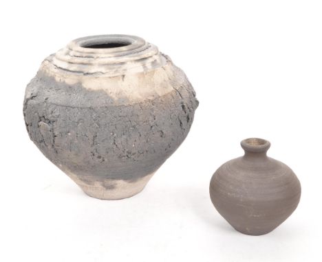 Two ceramic Cornish artisan stoneware studio pottery vases one of spherical form with mottled texture. The other a smaller ex