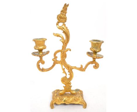 W. T. &amp; S - A early 20th century rococo Italian style gilt candelabra. With scrolled / flame middle with candle stick hol