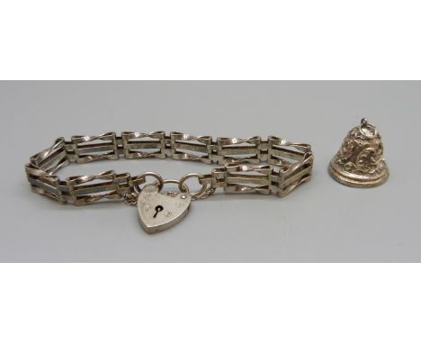 A silver gate bracelet and a silver charm, 17g 
