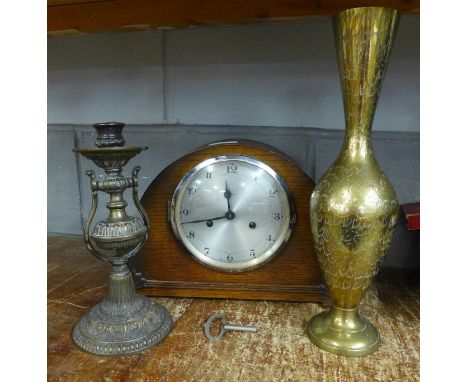 A 1930's mantle clock, a brass vase and a wall mounted candle holder 